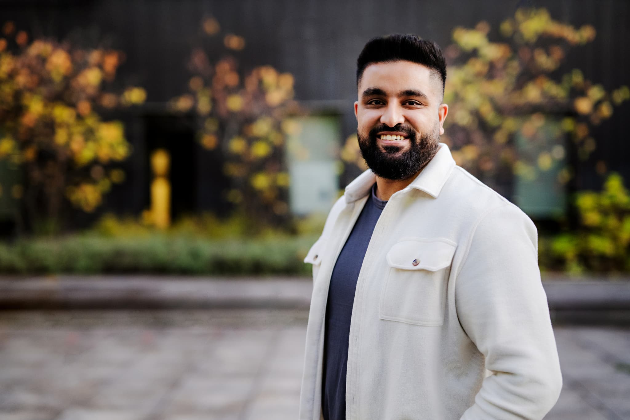 Student sitting on windowsill with skyscrapers in the background