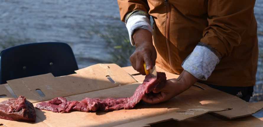 cutting meat at the camp
