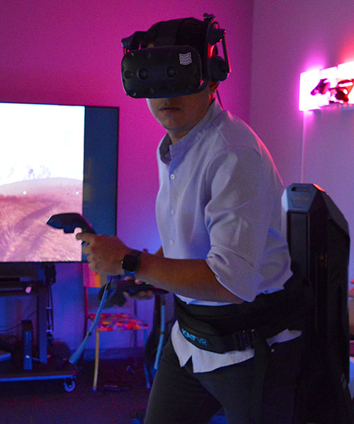John Munoz on an omnidirectional treadmill wearing a VR headset