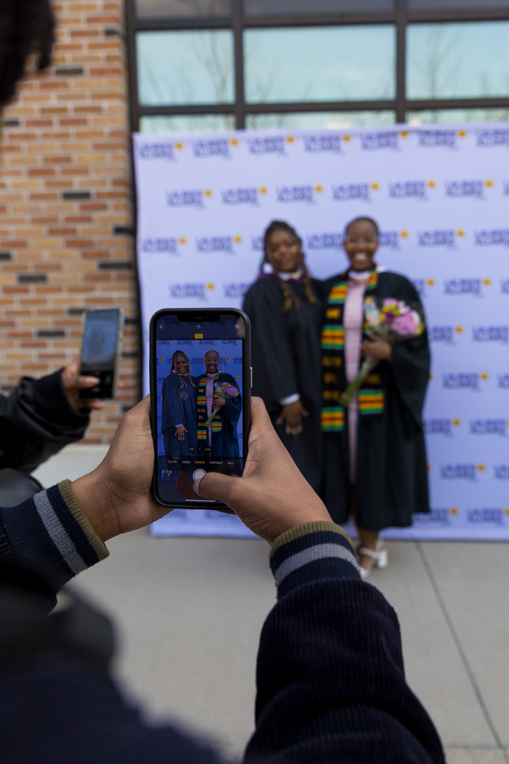 family taking photos of graduates